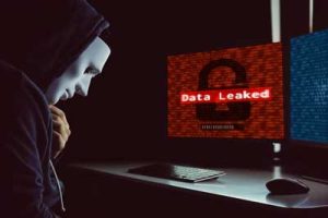 IT professionals responding to a data breach with warning alerts on monitors and security tools in use.