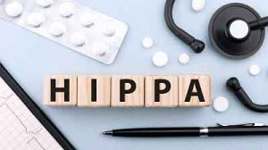 hipaa-compliance-implementation-services Healthcare professional using a tablet with security shield icon, representing HIPAA compliance and data protection.